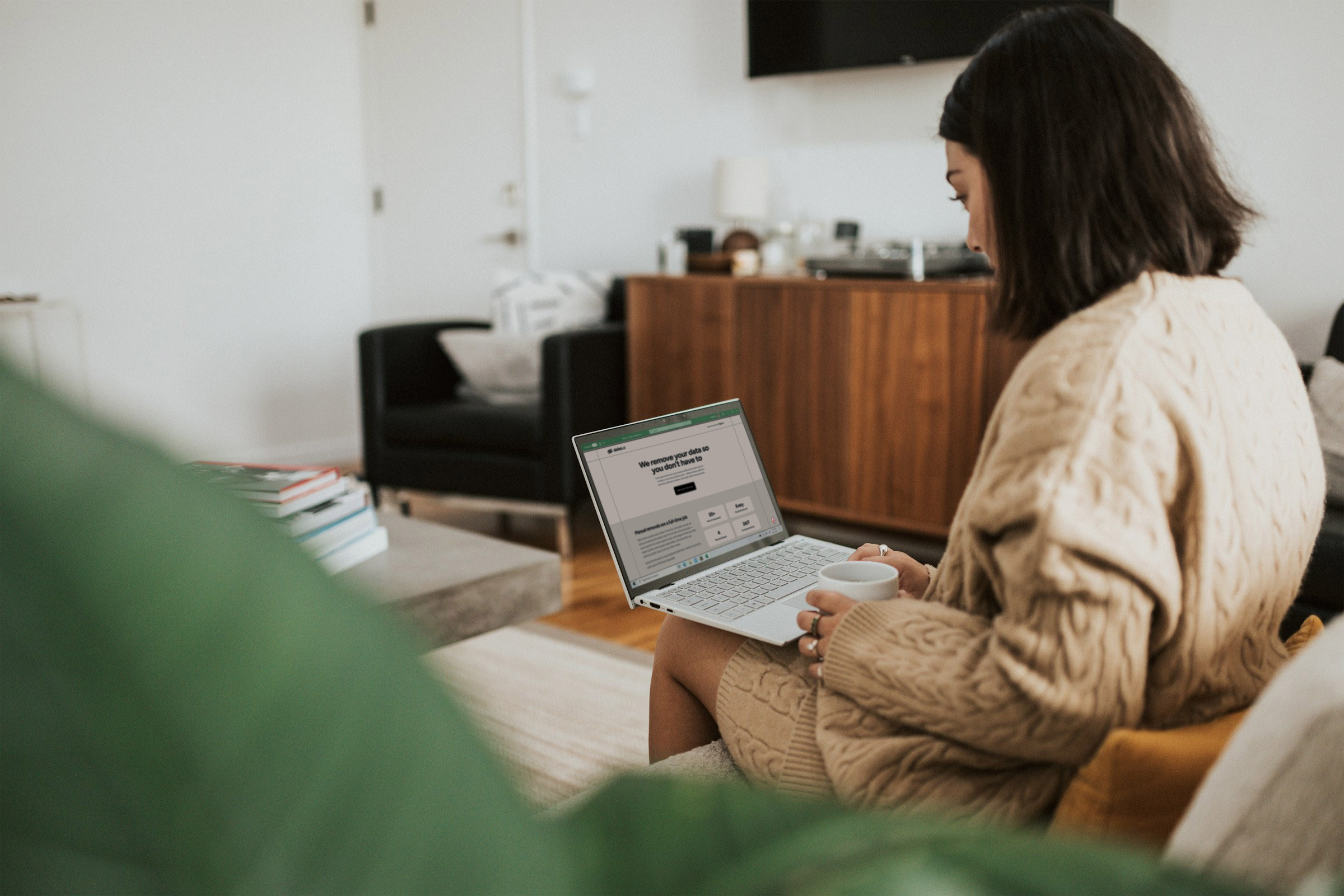 Person on a couch with a laptop.